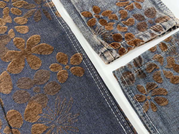 Flower jacquard denim fabric texture detail showing raised chenille floral effect