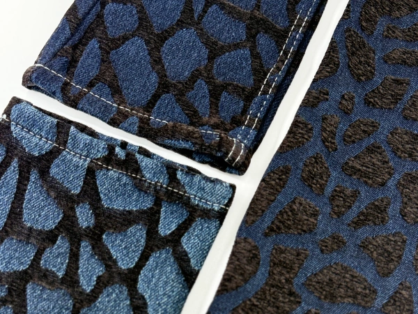Close-up of Quiet Erosion chenille jacquard denim fabric featuring organic stone-like textured surface.