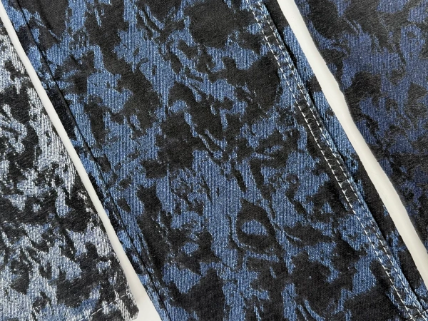Close-up of blue black chenille jacquard denim texture with raised flocking effect