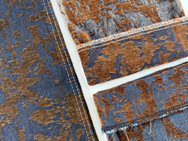 Close-up of blue brown chenille jacquard denim fabric with vintage texture effect_