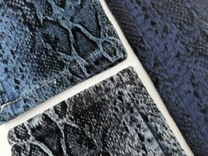 Dark indigo textured snake denim fabric developed with chenille jacquard construction