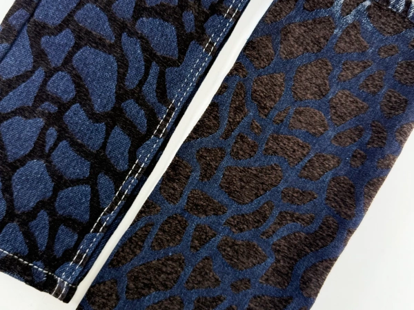 Dark wash textured denim fabric with dimensional chenille jacquard construction inspired by natural erosion patterns.