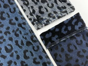 Closeup of brown leopard chenille jacquard denim fabric showing raised texture details_